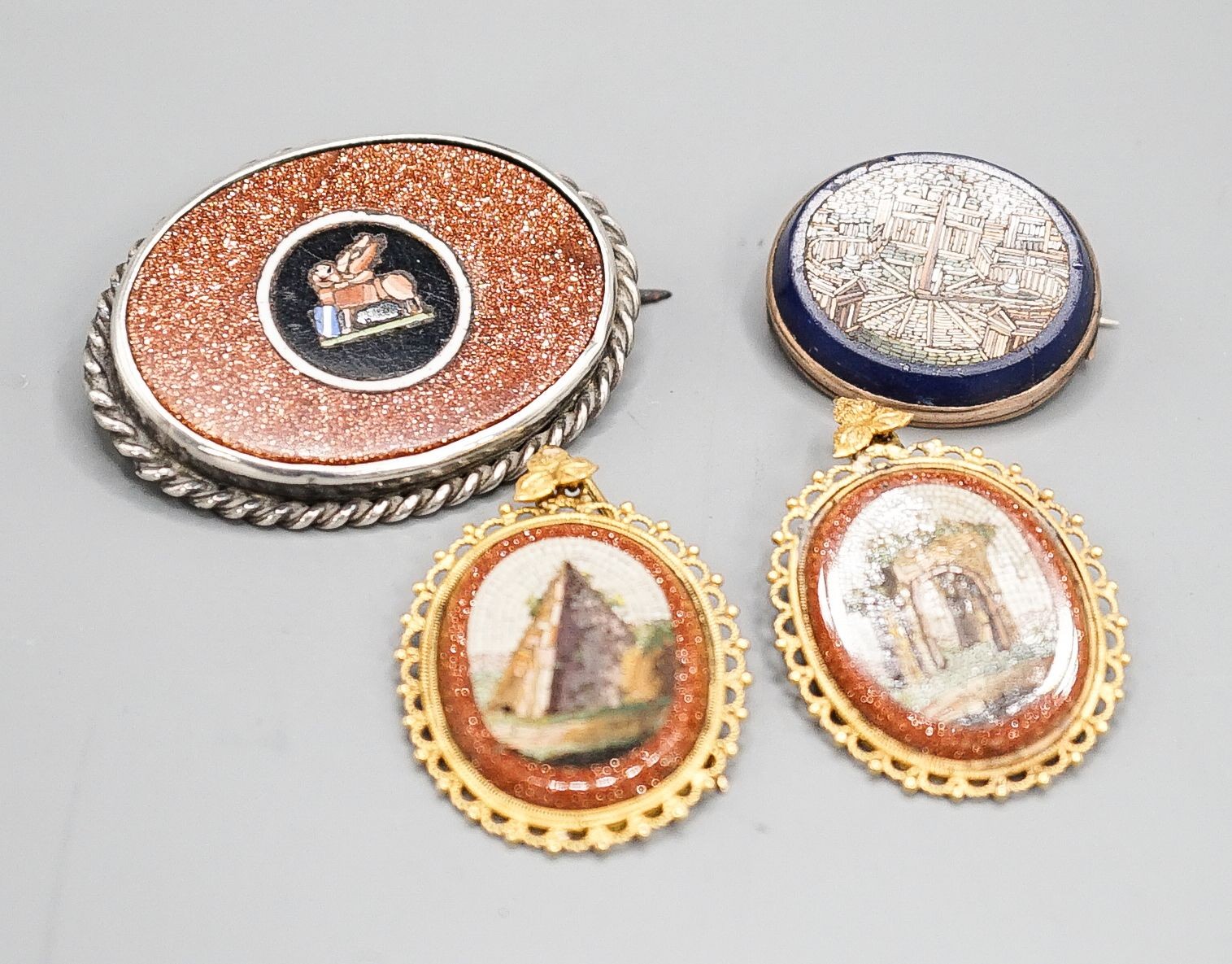 A pair of yellow metal mounted adventurine glass and micro mosaic oval earrings, decorated with ancient architecture, 32mm, a small micro mosaic oval brooch and a white metal mounted adventurine glass and micro mosaic ov